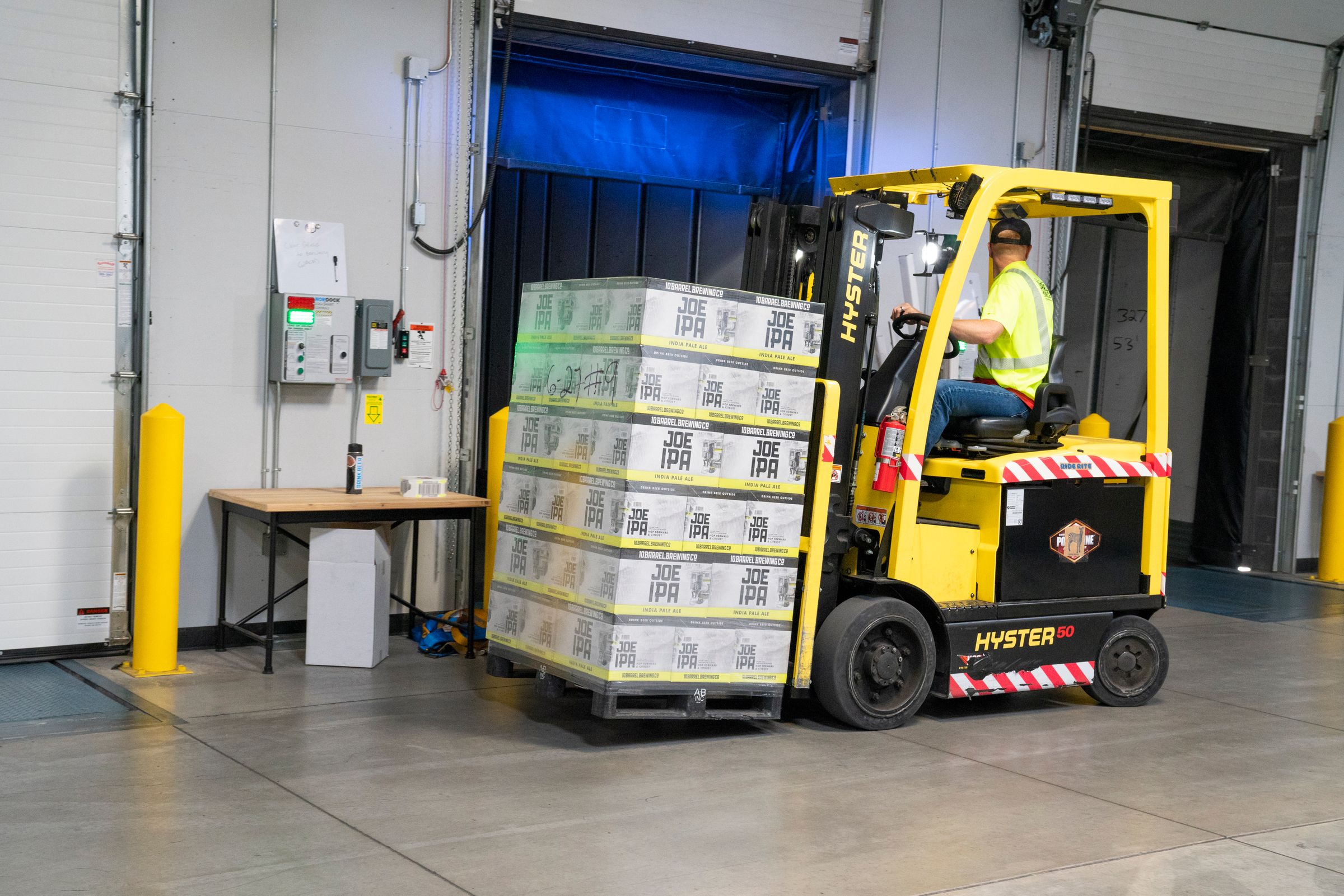 Forklift moving a loaded pallet inside a warehouse